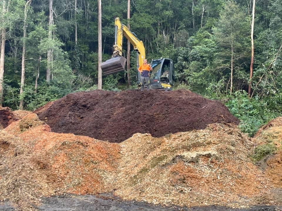 Large Mulch Pile at the Monkey Business Tree Service depot curing to sell as seasoned forest hardwood mulch